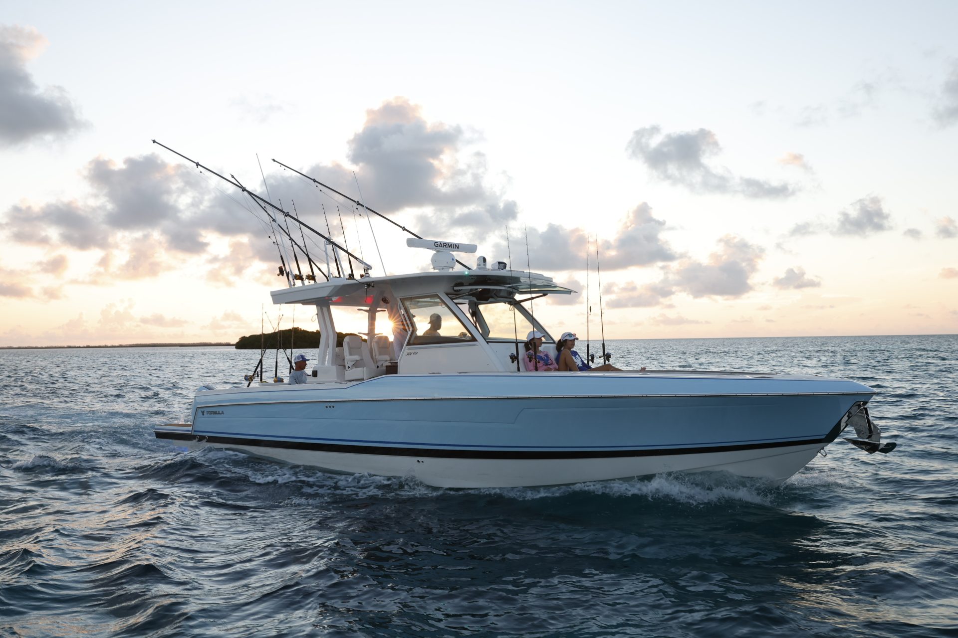 center console fishing boat on the water at sunset